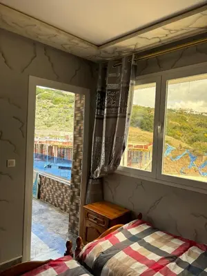 a bedroom with a bed and a window with a view at Absolute Calm & Panoramic Views in Oulad Akkou
