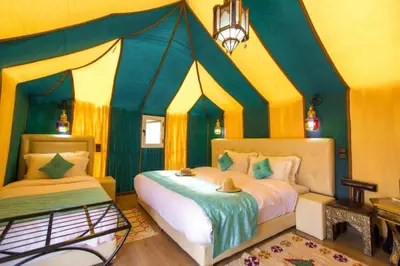 a bedroom with a bed with a canopy at Sahara Moon Camp in Merzouga