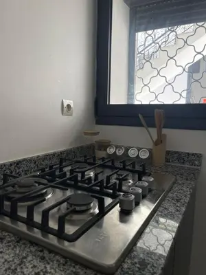 a stove top in a kitchen with a window at Apartment amina in Azrou