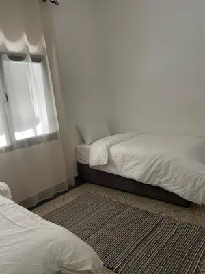 a bedroom with two beds and a window at Apartment amina in Azrou