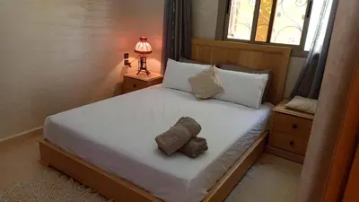 a bedroom with a bed with two towels on it at appartement lamia in Azrou