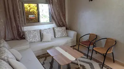 a living room with a couch and two chairs at appartement lamia in Azrou