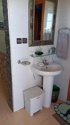 a bathroom with a sink and a mirror at appartement lamia in Azrou