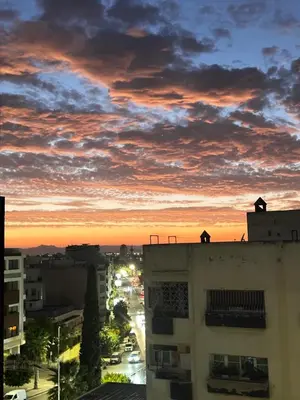 a person standing on top of a building at sunset at Résidence le petit clos in Fès