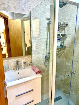 a bathroom with a sink and a shower at Charmant appartement meublé avec Wifi Fibre 100Mo in Fès