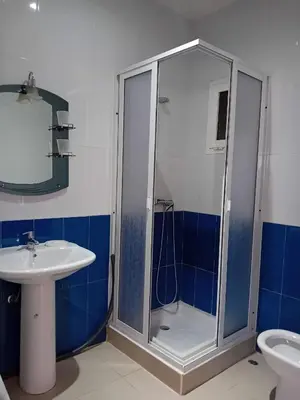 a bathroom with a shower and a sink at Al massira fnideq in Oulad Akkou