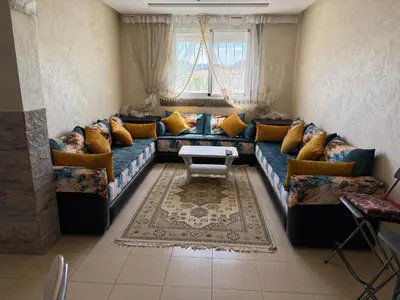 a living room with a blue couch with yellow pillows at Cozy & Affordable Family Apartment for married couples only in Ifrane