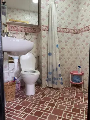 a bathroom with a toilet and a sink and a shower at Cozy & Affordable Family Apartment for married couples only in Ifrane