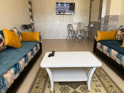 a living room with a couch and a table at Cozy & Affordable Family Apartment for married couples only in Ifrane