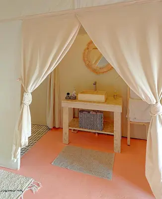 a dressing room with a table and a mirror at ALQADAR - Desert Lux Camp in Merzouga