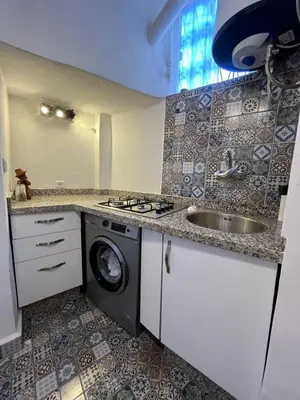 a kitchen with a sink and a washing machine at Dar Latifa in Fès