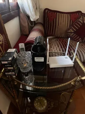 a coffee table with items on top of a couch at Apparemment fes la momie in Fès