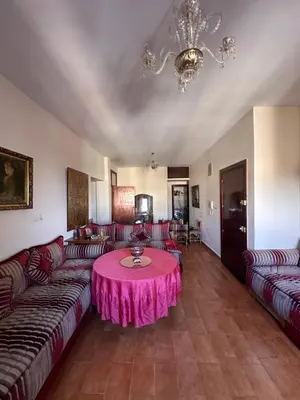 a living room with couches and a pink table at Apparemment fes la momie in Fès