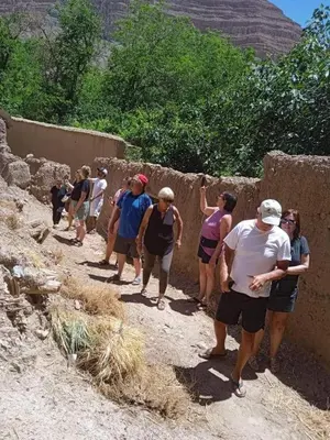 a group of people standing next to a wall at Auberge baddou amougar in Amouguer