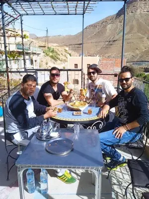 a group of men sitting around a table at Auberge baddou amougar in Amouguer