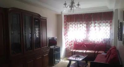 a living room with a couch and a table at Hotel ouelfa in Oulad Akkou