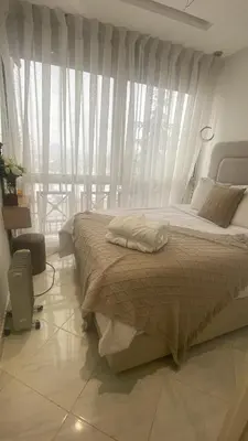 a bedroom with a large bed with a window at شقة فخمة in Ifrane
