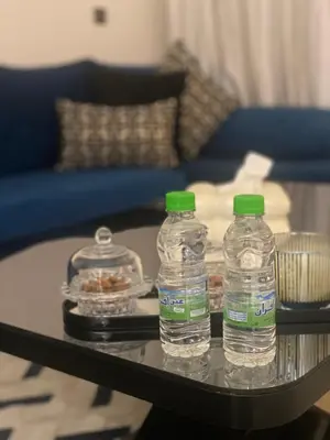 two bottles of water sitting on top of a table at شقة فخمة in Ifrane