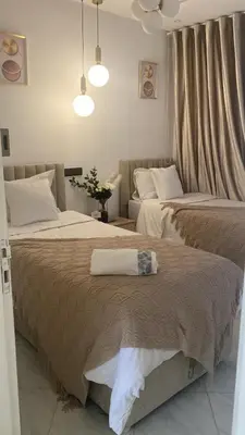 two beds sitting next to each other in a bedroom at شقة فخمة in Ifrane