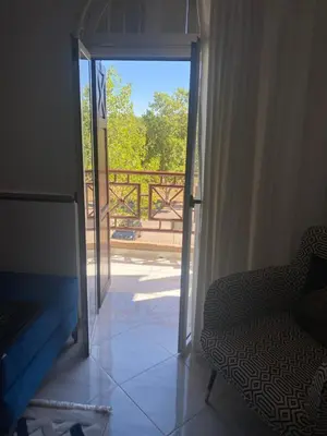 a room with a door open to a balcony at شقة فخمة وهادئة in Ifrane