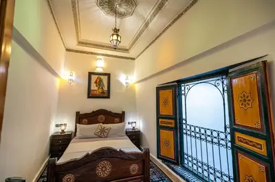 a bedroom with a bed and a window at Dar Alillouch in Fès