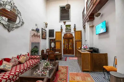 a living room with a couch and a table at Dar Alillouch in Fès