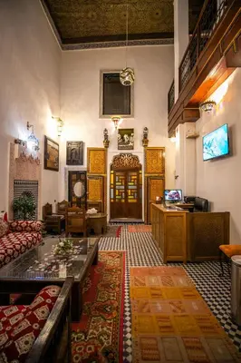 a living room with a couch and a table at Dar Alillouch in Fès