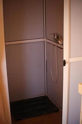 a shower stall with a hose in a bathroom at Sahara serenity camp in Merzouga