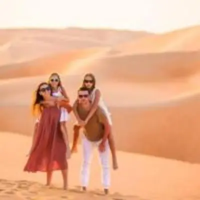 a group of three people standing in the desert at Sahara serenity camp in Merzouga
