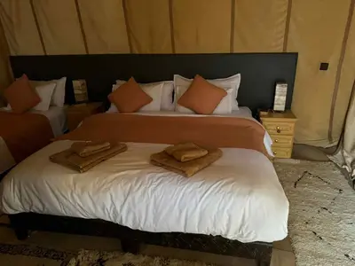 a bedroom with two towels on a bed at Sahara serenity camp in Merzouga