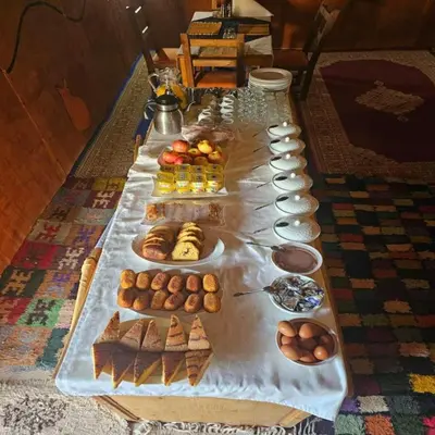 a long table filled with different types of pastries at Sahara serenity camp in Merzouga
