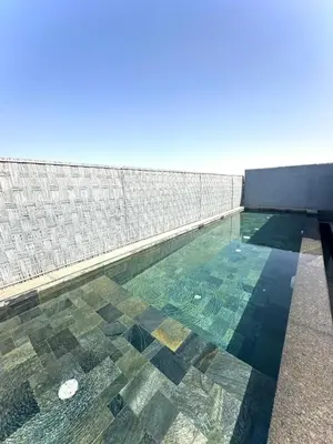 a swimming pool with a tile floor and a building at Rooftop avec Piscine privée - 2 chambres - Marrakech in Oulad Akkou