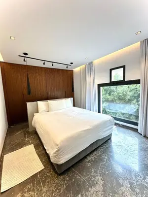 a bedroom with a large bed and a large window at Rooftop avec Piscine privée - 2 chambres - Marrakech in Oulad Akkou