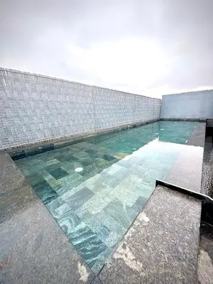 a swimming pool with glass floors and a wall at Rooftop avec Piscine privée - 2 chambres - Marrakech in Oulad Akkou