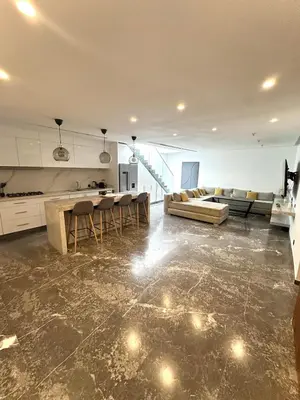 a large living room with a couch and a table at Rooftop avec Piscine privée - 2 chambres - Marrakech in Oulad Akkou