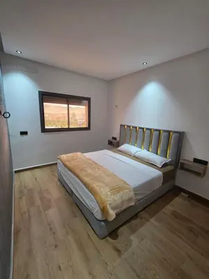 a bedroom with a large bed in a room with a window at appartement moderne khenifra 2 in Khenifra