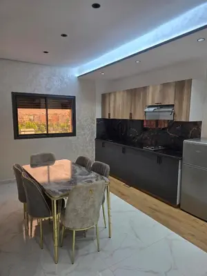 a kitchen and dining room with a table and chairs at appartement moderne khenifra 2 in Khenifra