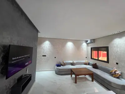 a living room with a couch and a flat screen tv at appartement moderne khenifra 2 in Khenifra