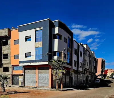 a building with a palm tree in front of it at appartement moderne khenifra 2 in Khenifra