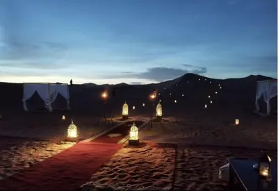 a group of lights in the desert at night at Sahara Classic Luxury Camp in Merzouga