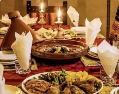 a table with plates of food on top of it at Sahara Classic Luxury Camp in Merzouga