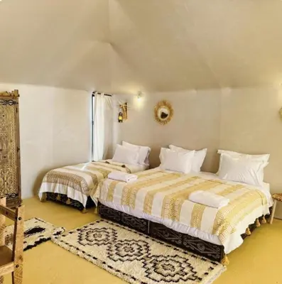 two beds sitting next to each other in a bedroom at Sahara Classic Luxury Camp in Merzouga