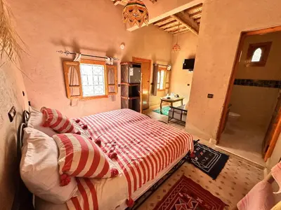 a bedroom with a large bed in a room at Nana Diafa - Zagora Guest House & Restaurant in Zagora