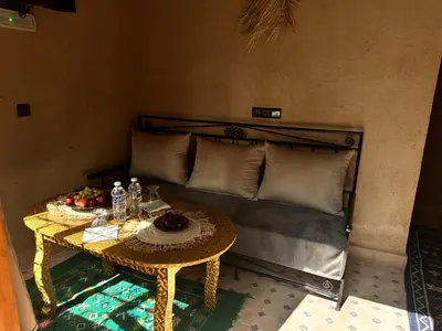 a room with a bed with a table with fruit on it at Nana Diafa - Zagora Guest House & Restaurant in Zagora