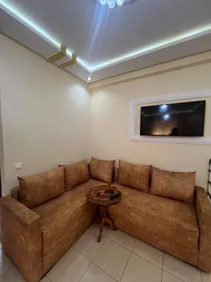 a brown couch in a living room with a tv at Stylish & Spacious Apartment in Peaceful Ifrane in Ifrane