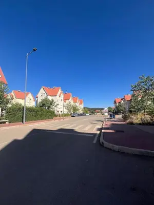 an empty street in a residential neighborhood with houses at Stylish & Spacious Apartment in Peaceful Ifrane in Ifrane