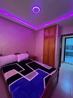 a bedroom with a purple ceiling with a bed at Stylish & Spacious Apartment in Peaceful Ifrane in Ifrane