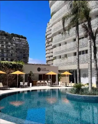 a large swimming pool in front of a building at CFC - Douceur et luminosité in Oulad Akkou