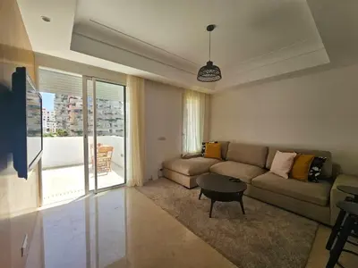 a living room with a couch and a table at CFC - Douceur et luminosité in Oulad Akkou