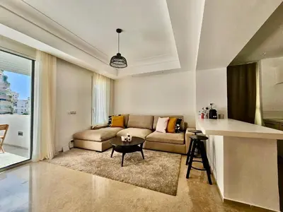 a living room with a couch and a table at CFC - Douceur et luminosité in Oulad Akkou